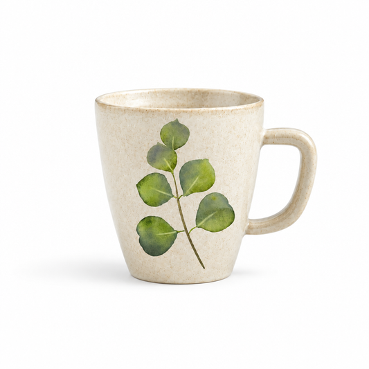 Cream tapered mug with green leaf artwork on white background